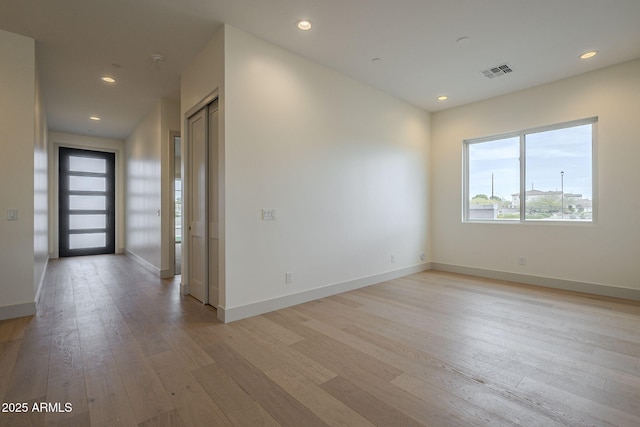 spare room with light hardwood / wood-style flooring