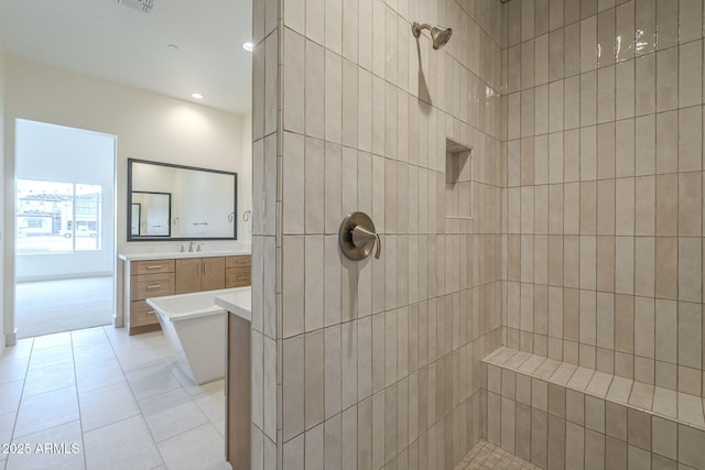 bathroom featuring tile patterned flooring, vanity, and separate shower and tub