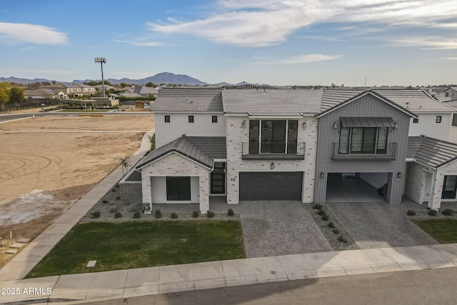 view of front facade featuring a mountain view and a garage