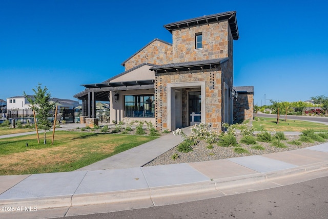 view of front of house with a front yard and a pergola