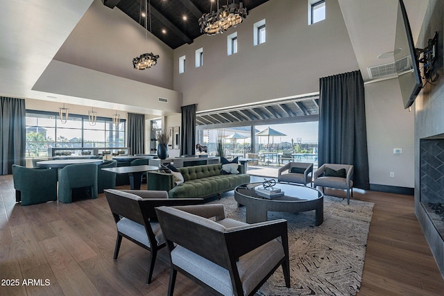 living room featuring hardwood / wood-style flooring, plenty of natural light, and a notable chandelier