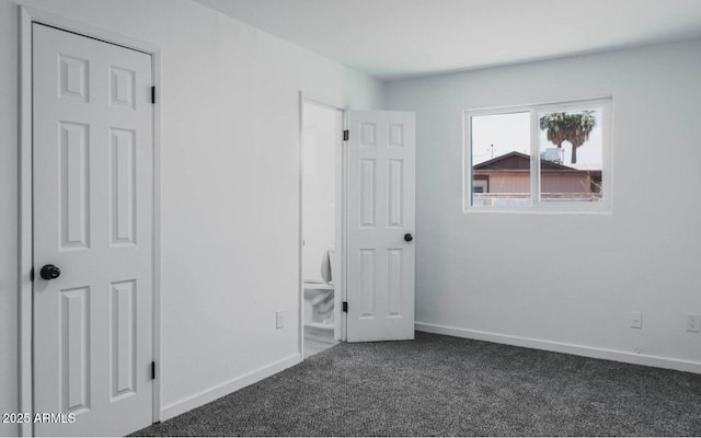 unfurnished bedroom with dark carpet