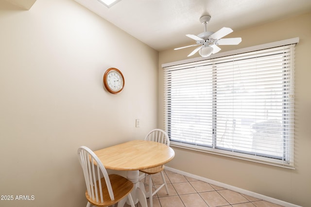 tiled dining room featuring ceiling fan and vaulted ceiling