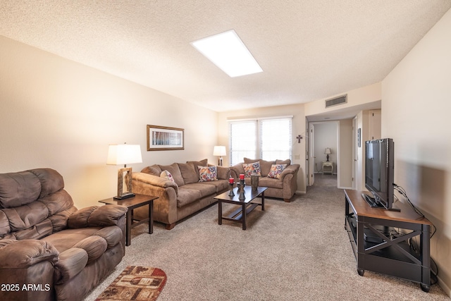 carpeted living room with a textured ceiling