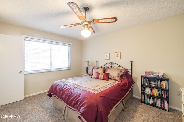 carpeted bedroom featuring ceiling fan and a textured ceiling