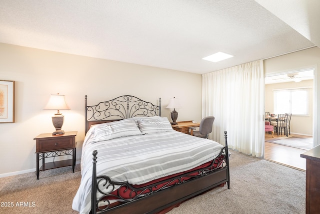 bedroom featuring light colored carpet and a textured ceiling