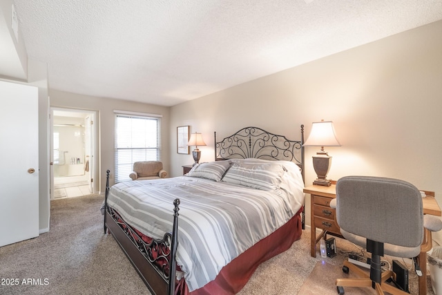 carpeted bedroom featuring a textured ceiling and ensuite bath