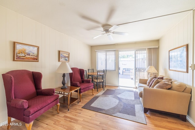 living room with ceiling fan and light hardwood / wood-style flooring