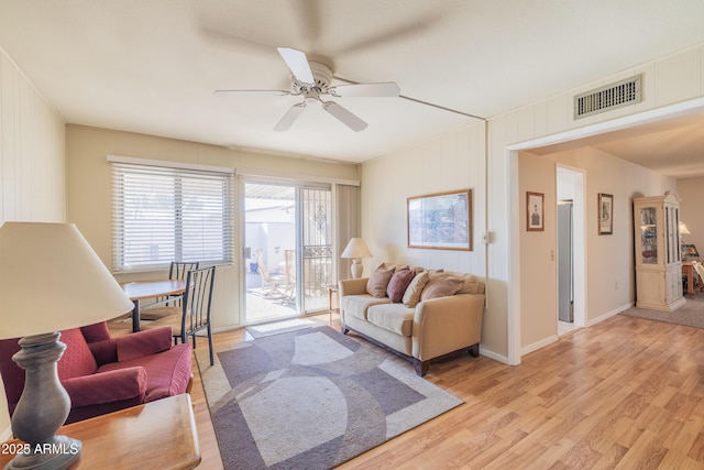 living room featuring ceiling fan and light hardwood / wood-style floors