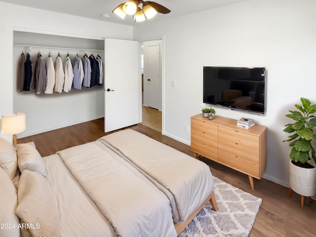 bedroom featuring dark hardwood / wood-style floors, ceiling fan, and a closet