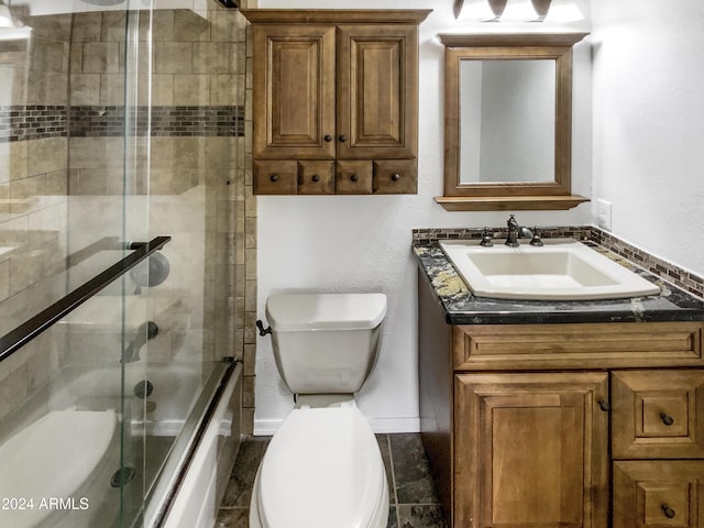 full bathroom with shower / bath combination with glass door, vanity, and toilet