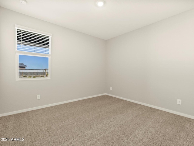 empty room with carpet floors and baseboards