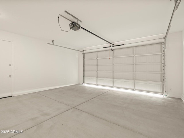 garage with baseboards and a garage door opener