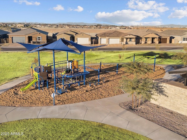 community playground featuring a residential view and a yard