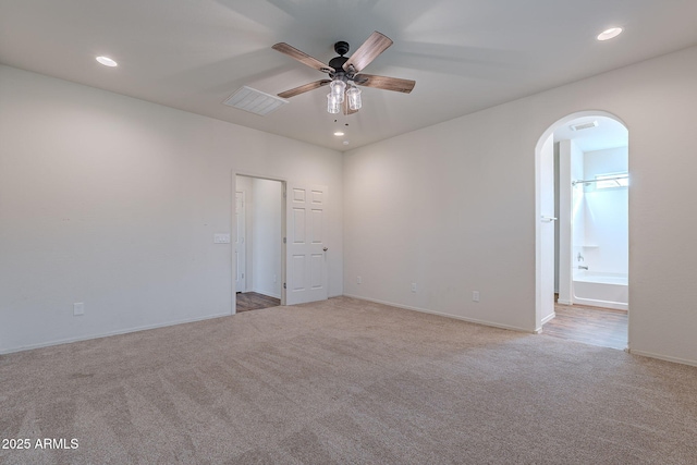 carpeted empty room featuring ceiling fan