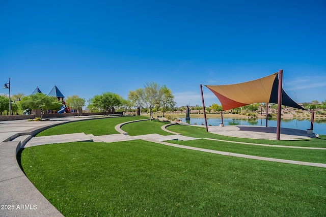 view of community with a water view and a yard