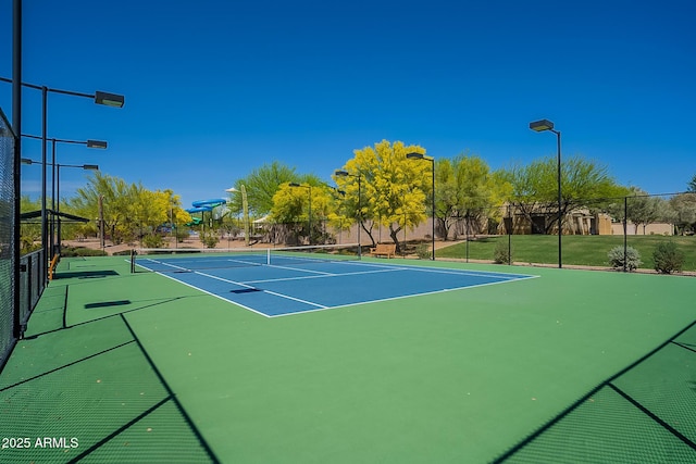 view of tennis court with basketball hoop