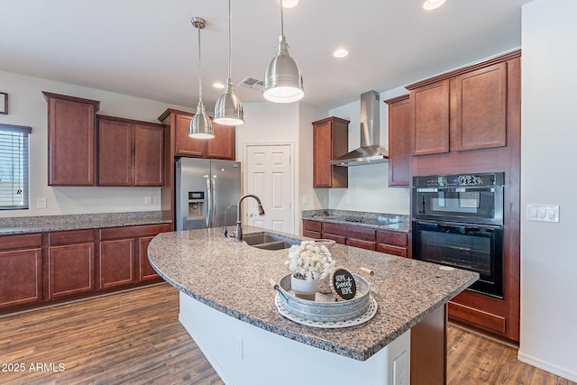 kitchen featuring black appliances, dark hardwood / wood-style flooring, a center island with sink, and wall chimney range hood