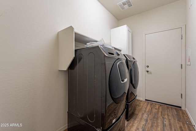 washroom featuring dark hardwood / wood-style floors and independent washer and dryer