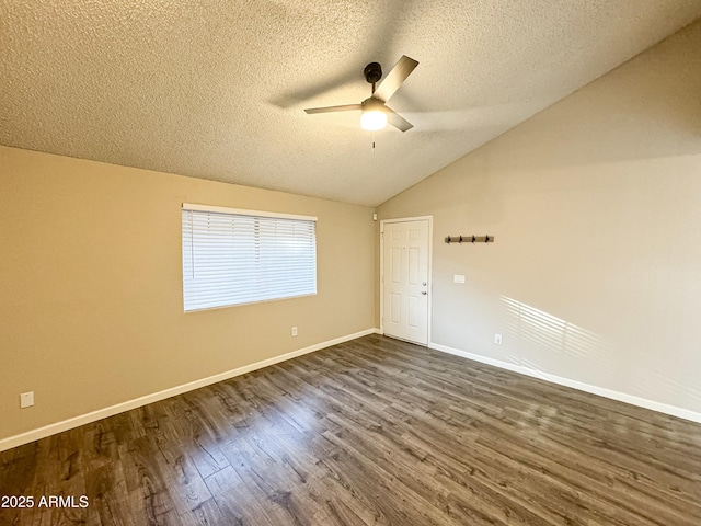 unfurnished room with a textured ceiling, dark hardwood / wood-style flooring, ceiling fan, and lofted ceiling