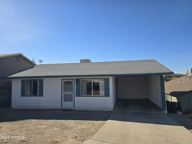 single story home featuring a carport