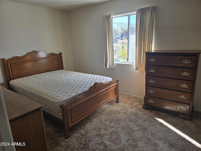 carpeted bedroom with a textured ceiling