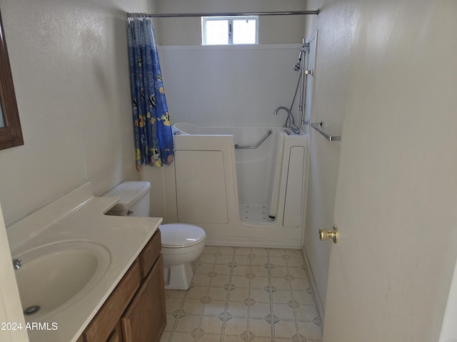 bathroom with curtained shower, vanity, and toilet