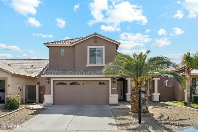 view of front of house with a garage, a tile roof, driveway, and stucco siding