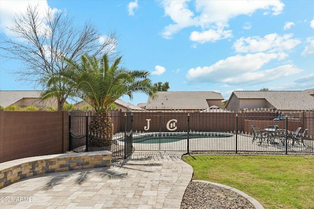 view of swimming pool with a patio area and a fenced backyard