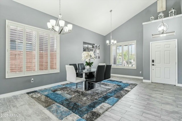 dining area with wood tiled floor, a notable chandelier, and baseboards