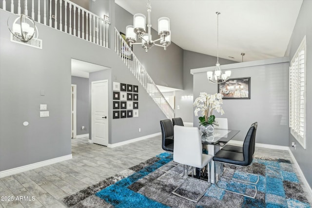 dining room featuring a chandelier, wood finished floors, and baseboards