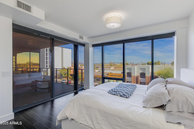 bedroom featuring hardwood / wood-style flooring and access to outside