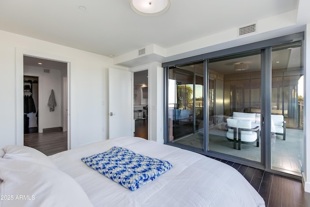 bedroom featuring access to outside and dark hardwood / wood-style floors