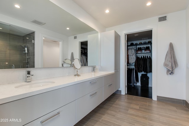 bathroom featuring vanity and an enclosed shower