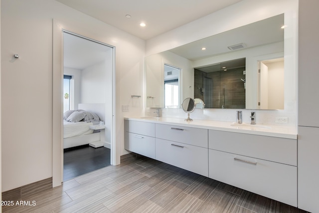 bathroom featuring vanity and a shower with door