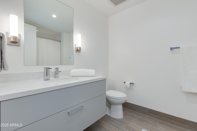 bathroom featuring vanity and toilet