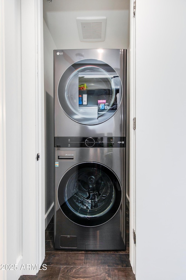 laundry area with stacked washer and dryer