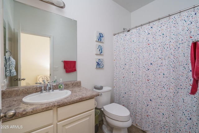 bathroom with vanity, walk in shower, and toilet