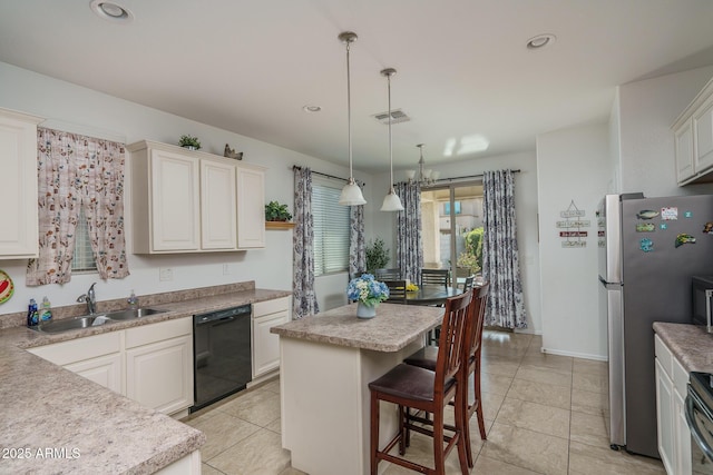 kitchen featuring pendant lighting, sink, stainless steel refrigerator, dishwasher, and a center island