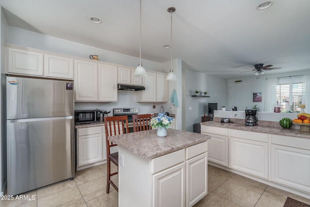 kitchen featuring appliances with stainless steel finishes, a center island, pendant lighting, and light tile patterned floors