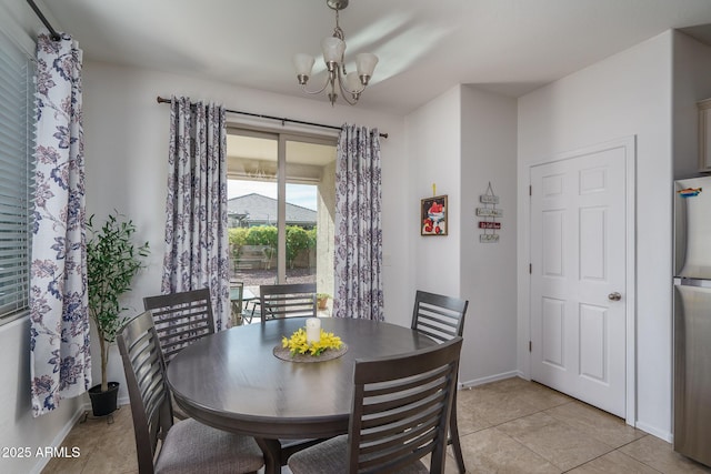 dining space featuring an inviting chandelier and light tile patterned floors