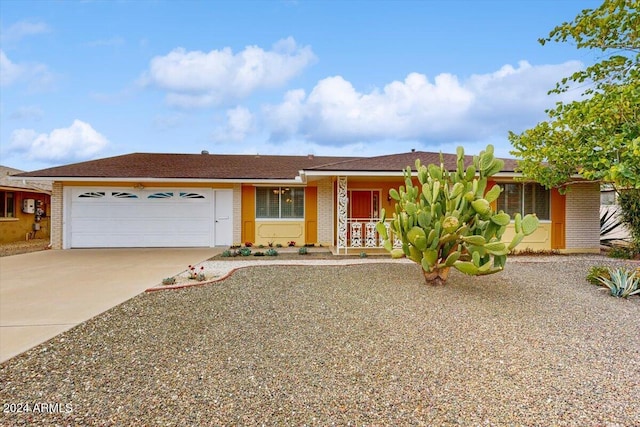 ranch-style house featuring a garage and covered porch