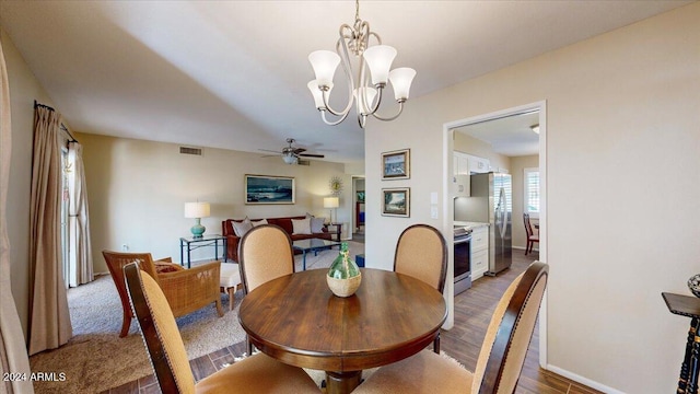 dining room with ceiling fan with notable chandelier and hardwood / wood-style flooring