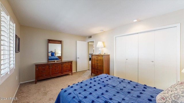 bedroom featuring a closet and light colored carpet