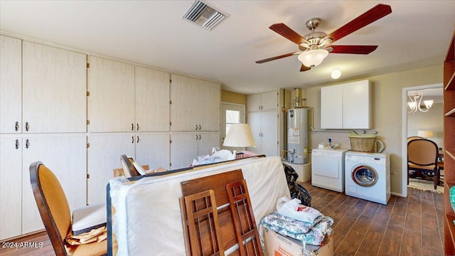 washroom featuring cabinets, ceiling fan, dark hardwood / wood-style floors, gas water heater, and washer and dryer