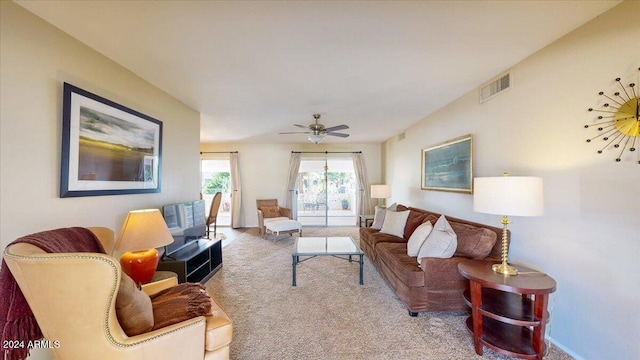 carpeted living room with ceiling fan