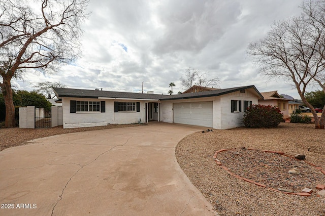 ranch-style home featuring brick siding, driveway, and an attached garage