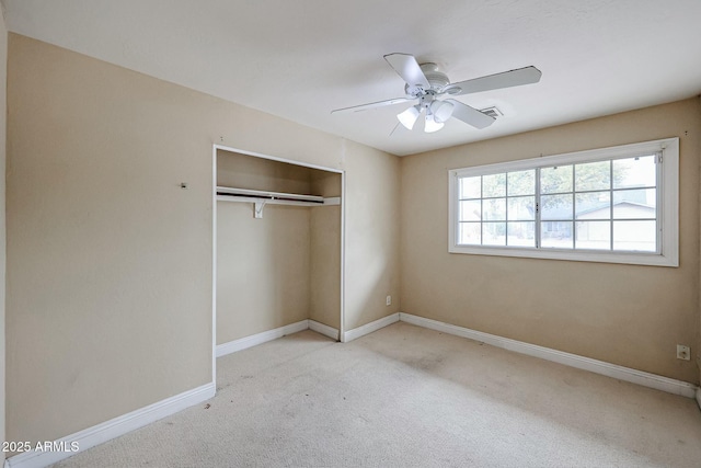 unfurnished bedroom with light carpet, visible vents, baseboards, a ceiling fan, and a closet