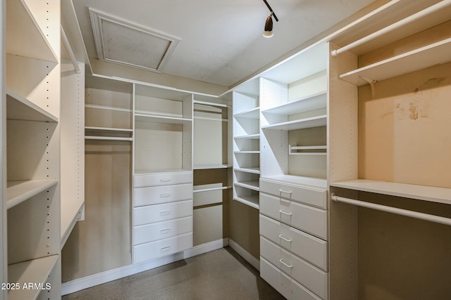 spacious closet featuring attic access