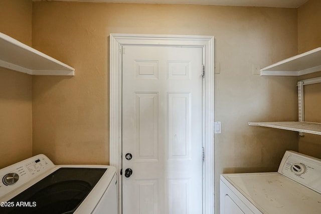 clothes washing area featuring laundry area and washer / dryer